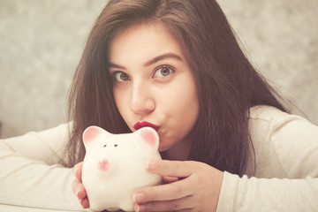 Beautiful young girl saving money for holiday season, saving money concept