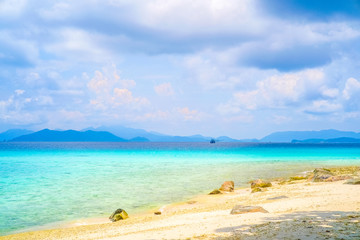 Sea view from tropical beach with sunny sky. Summer paradise beach of island. Exotic summer beach with clouds on horizon.