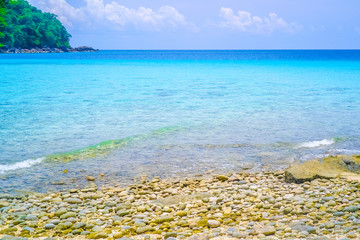 Sea view from tropical beach with sunny sky. Summer paradise beach of island. Exotic summer beach with clouds on horizon.