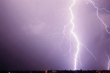 Naklejka na ściany i meble Thunderstorm in the sky with a beautiful lightning discharge