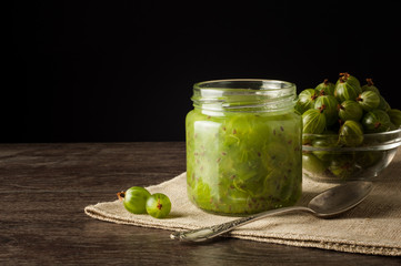 Gooseberry smoothie in a jar on a brown table