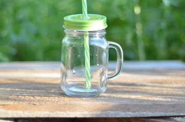 Bank for smoothies on a background of foliage cooking process