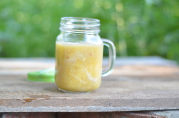 Bank for smoothies on a background of foliage cooking process