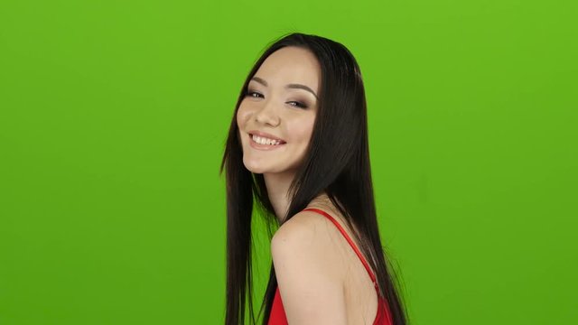 Asian girl posing in camera and she smiling. Green screen