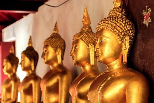 closeup golden buddha with soft-focus and over light in the background