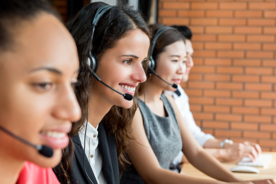 Smiling multiethnic telemarketing customer service agents, call center job concept
