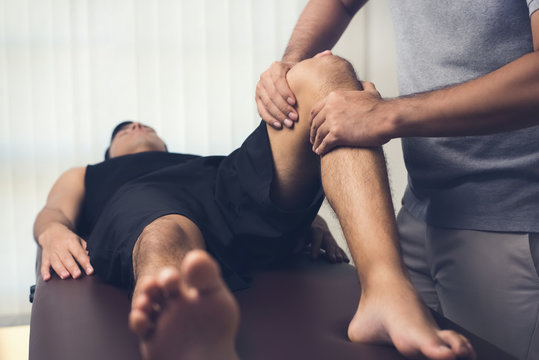 Physiotherapist treating athlete male patient