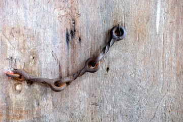 Close-up Old Steel Hook on Wooden Grunge Door.