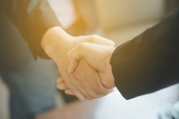 Fototapeta premium Business people shaking hands, finishing up a meeting, shaking hands success deal, Young businesswoman going to make handshake with a businessman -greeting, dealing, merger and acquisition concepts