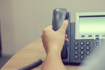 Close up man hand holding speaker phone for talking with colleagues or customer , life in office...