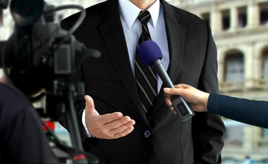 Close-up press interview with a man in black suit