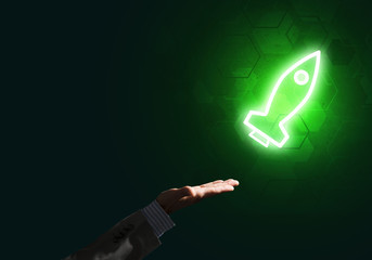 Man palm presenting Rocket web icon as technology concept