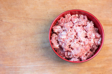 Fototapeta na wymiar Fresh raw minced meat on a cutting board, top view close-up