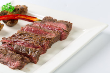 Juicy steak medium rare beef with spices and grilled vegetables
