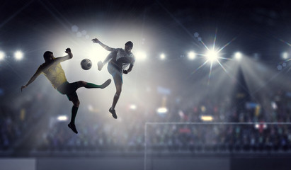 Silhouettes of two soccer players . Mixed media