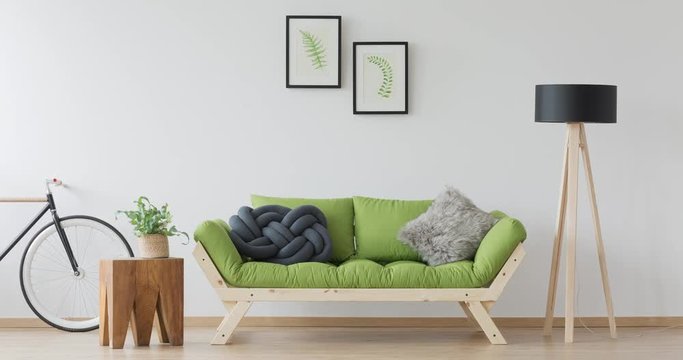 Bike standing next to the wooden green sofa