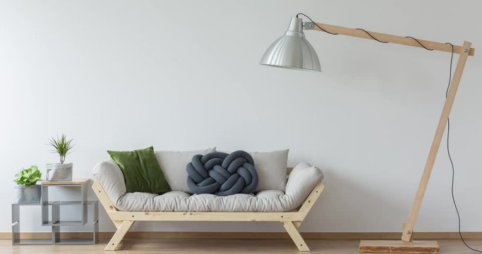 Cozy room with sofa and bike behind oversize lamp