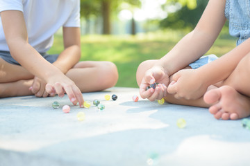 Obraz na płótnie Canvas Kids playing marbles game outside