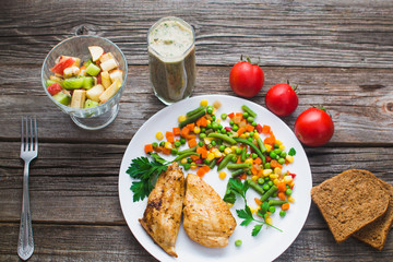 Breakfast on the wooden background from chicken breast