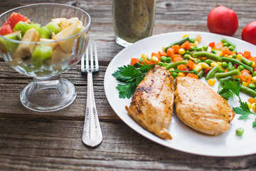 Breakfast on the wooden background from chicken breast