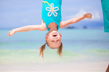 Adorable funny little girl outdoors during summer vacation have fun with her young father
