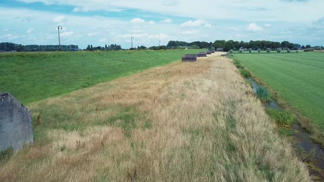 Aerial of old shelter bunkers from world war two in the middle of a meadow near Culemborg, the Netherlands &ndash; 4K