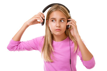 Lovely teenage girl removing her headphones for noise or loud music isolated