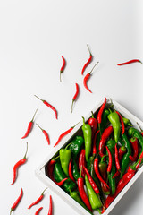 Red and green peppers in the wooden box