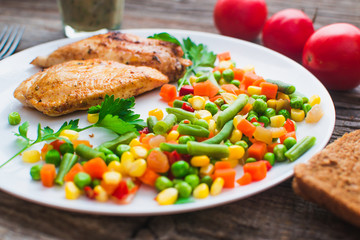 Breakfast on the wooden background from chicken breast