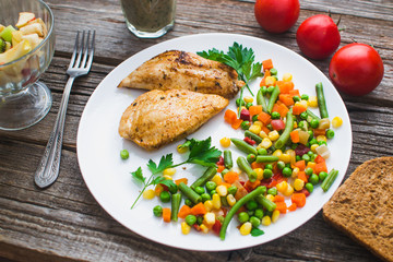 Breakfast on the wooden background from chicken breast