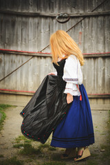 Beautiful woman posing outdoor in traditional Romanian costume