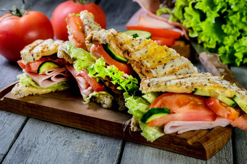 Panini sandwich with ham, tomato and lettuce.