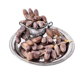 Fresh fruit dates in a silver metal bowl on a  isolated  white background