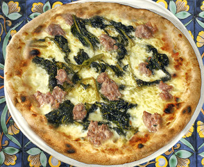 Italy,Naples; pizza with sausage and a particular kind of turnip tops "friarielli".