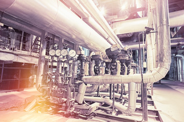 Equipment, cables and piping as found inside of a modern industrial power plant