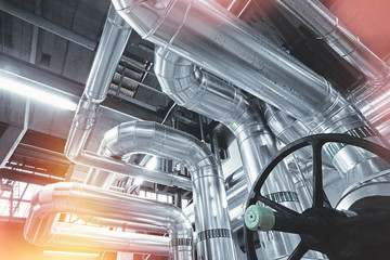 Equipment, cables and piping as found inside of a modern industrial power plant