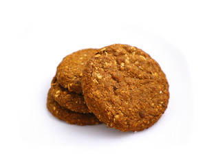 A pile of four healthy brown detailed cereal chocolate cookies. .Cereal roundish cookies, vegan breakfast consent. Macro, close up view.