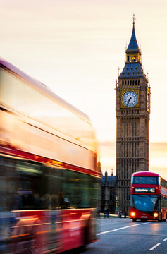 London night scene of Westminster and Big Ben with famous London bus driving by