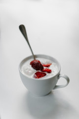 Ice cream with strawberries in a cup on the table