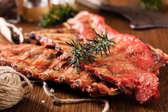 Smoked ribs on wooden table.