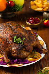 Baked whole duck, served with apples, red cabbage, oranges and roasted fritters.