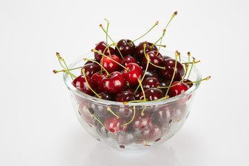 Cherries in a bowl isolated on white background. 