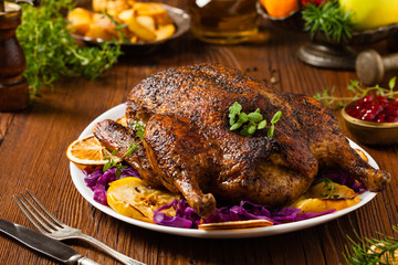 Baked whole duck, served with apples, red cabbage, oranges and roasted fritters.
