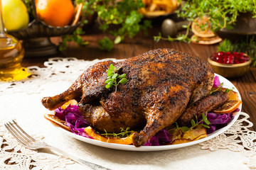 Baked whole duck, served with apples, red cabbage, oranges and roasted fritters.