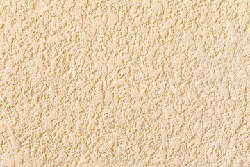 Beige rough wall texture for background.
