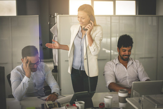 Business People Working In Office. Business Woman Talking On Landline Phone.