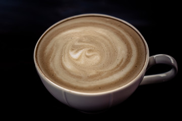 Beautiful late coffee on black wood background.