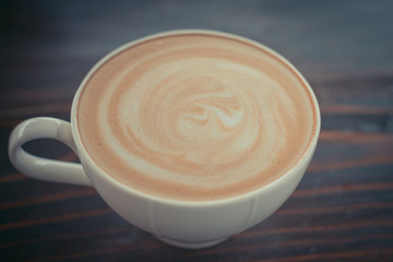 Beautiful late coffee on black wood background.