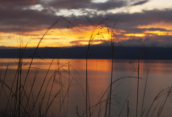 Beautiful Baikal sunset, golden evening sunset on Baikal, Siberian nature and landscape