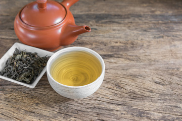 cup of chinese tea on old and crack wooden surface, healthy beverage concept